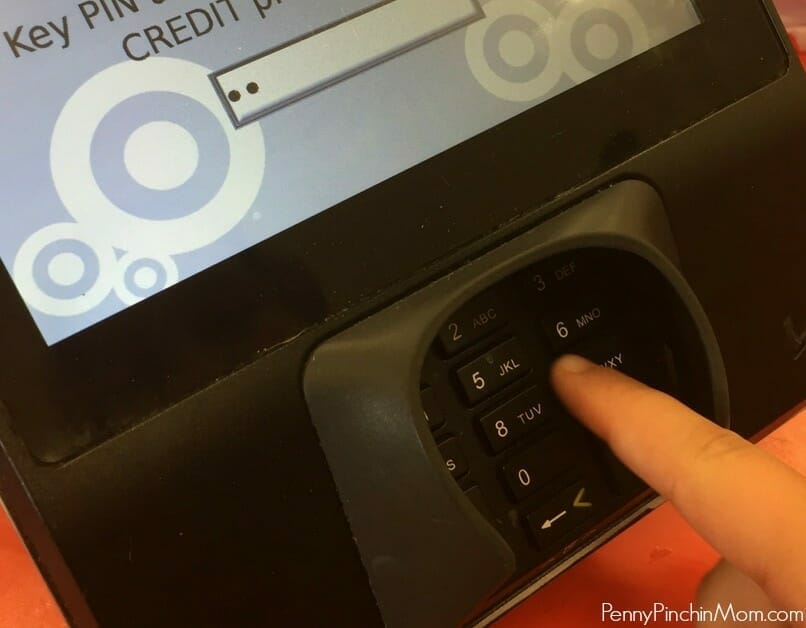 hand pressing numbers on credit pad